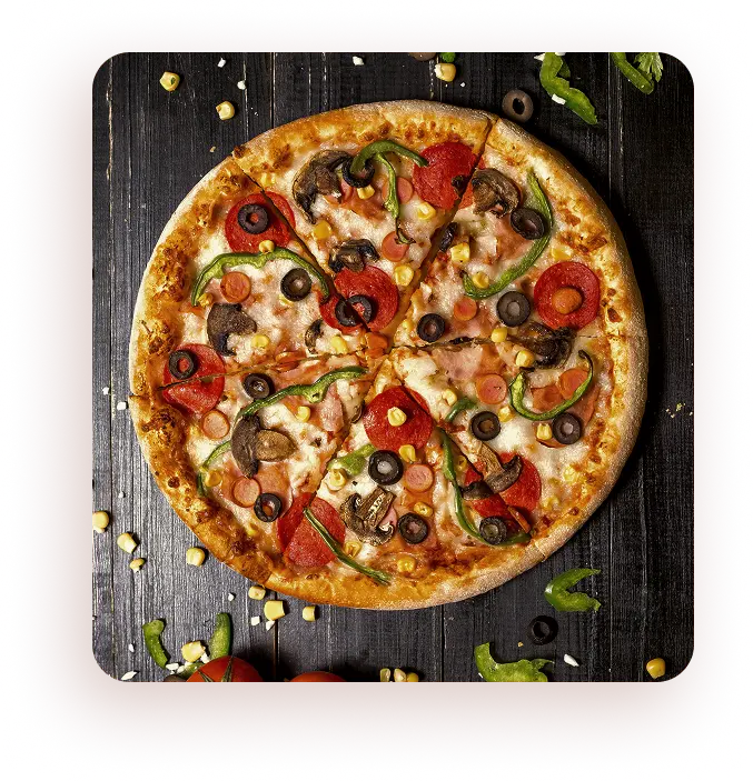 Close-up of freshly baked pizza with pepperoni, mushrooms, olives, and green peppers on a dark wooden table.