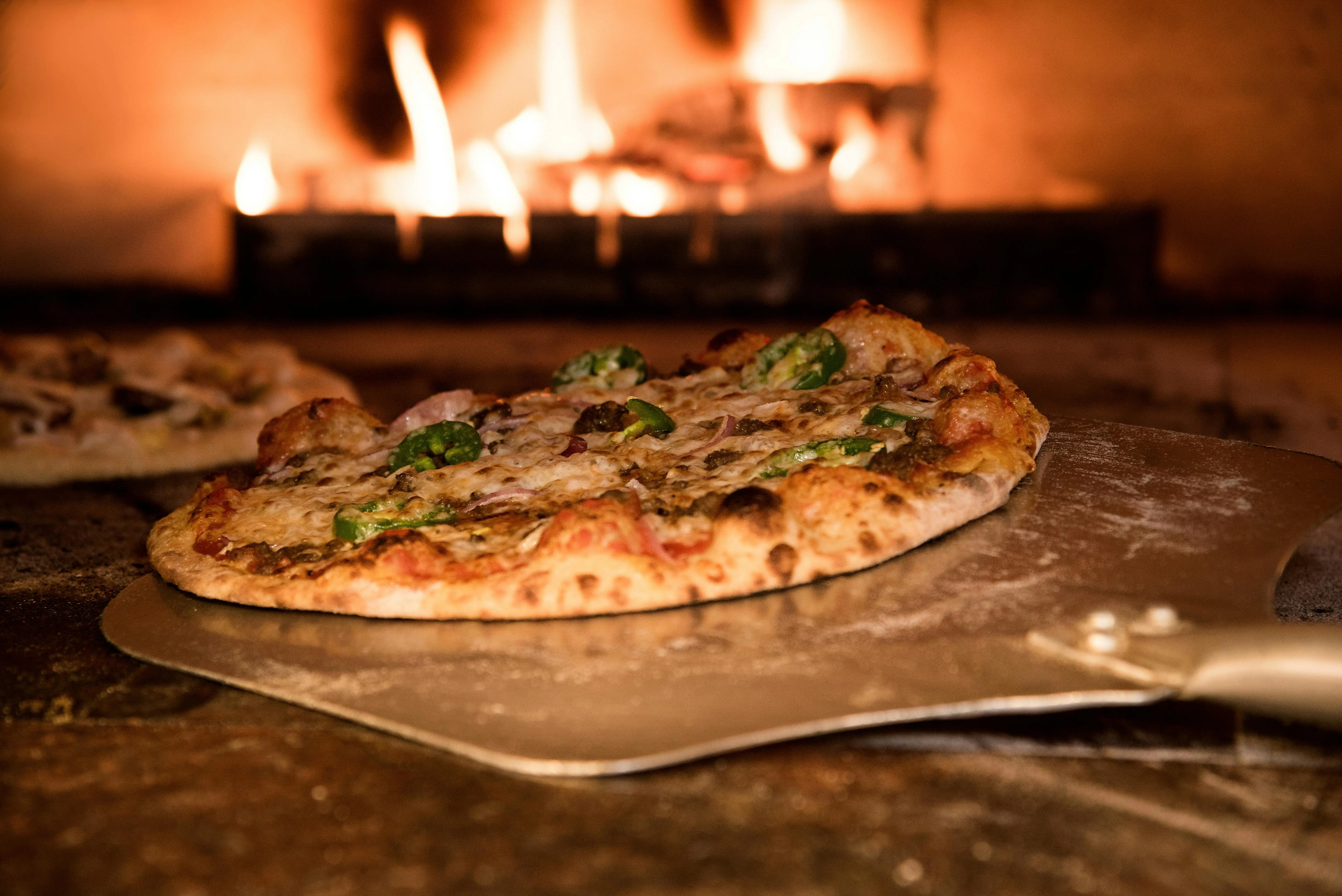 Fresh pizza baking in a wood-fired oven