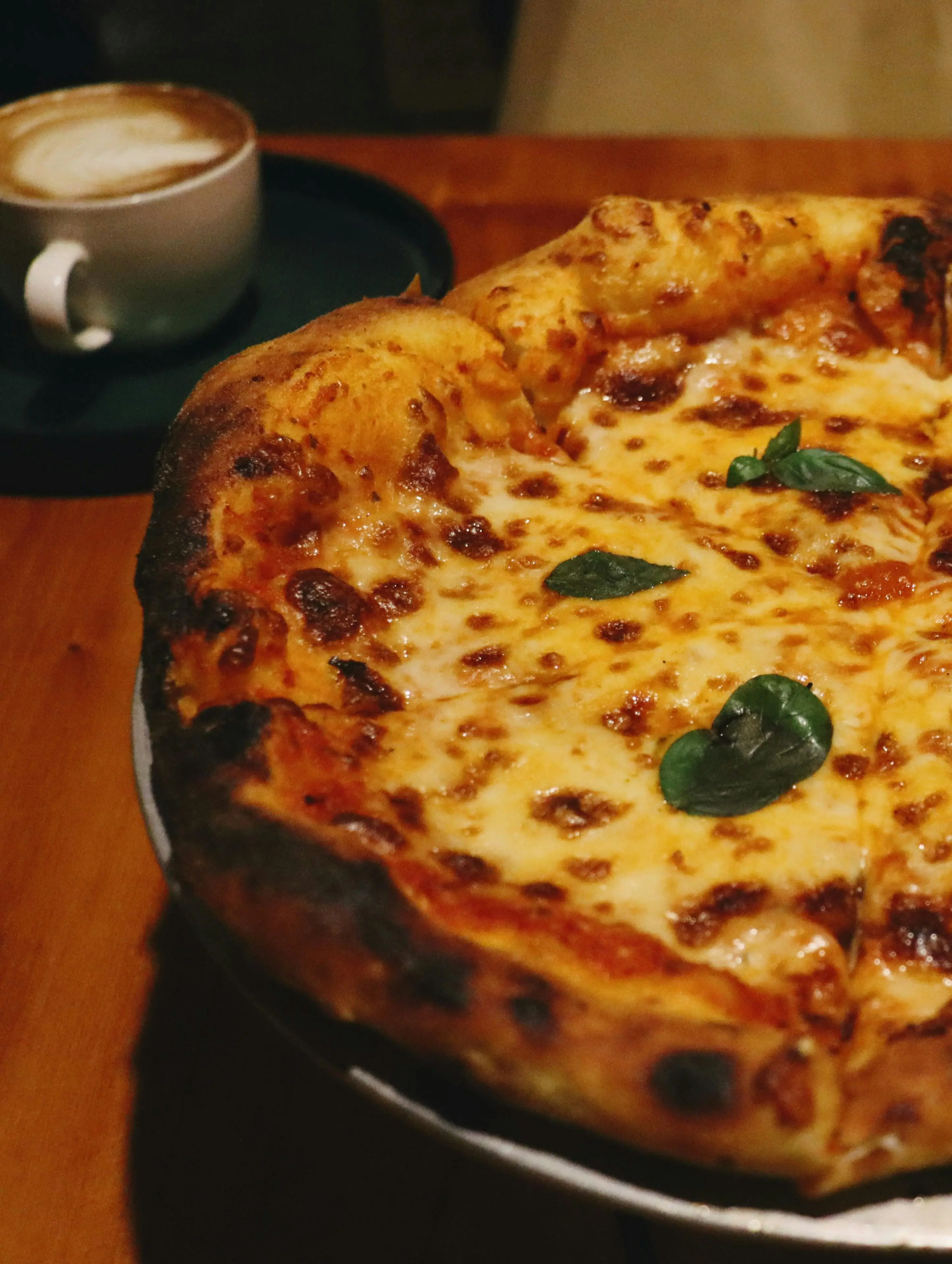 Fresh pizza served with a pot of Italian coffee